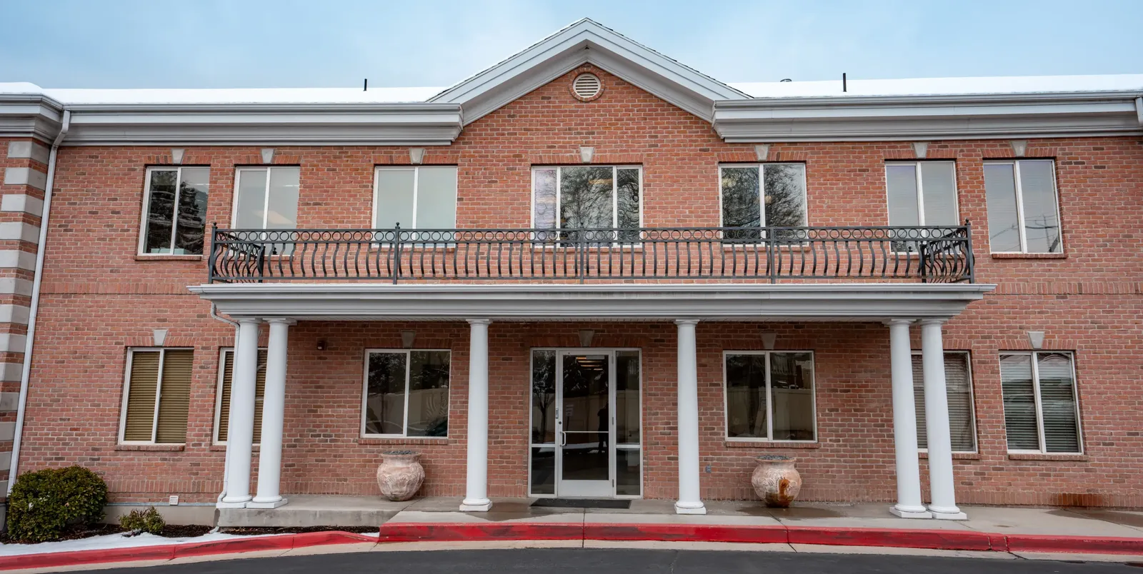 Front entrance of the Cottonwood Heights office under a columned balcony | Complete Smiles-Cottonwood Heights-Mountain View-Redwood-Utah