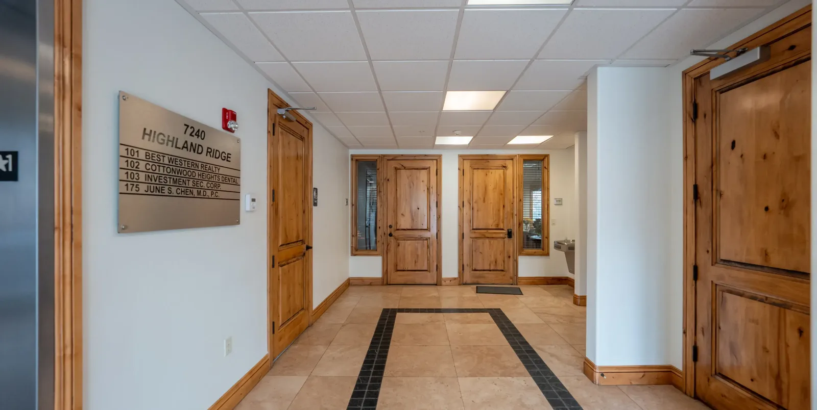 Entry hallway with wood doors and the Highland Ridge building directory | Complete Smiles-Cottonwood Heights-Mountain View-Redwood-Utah