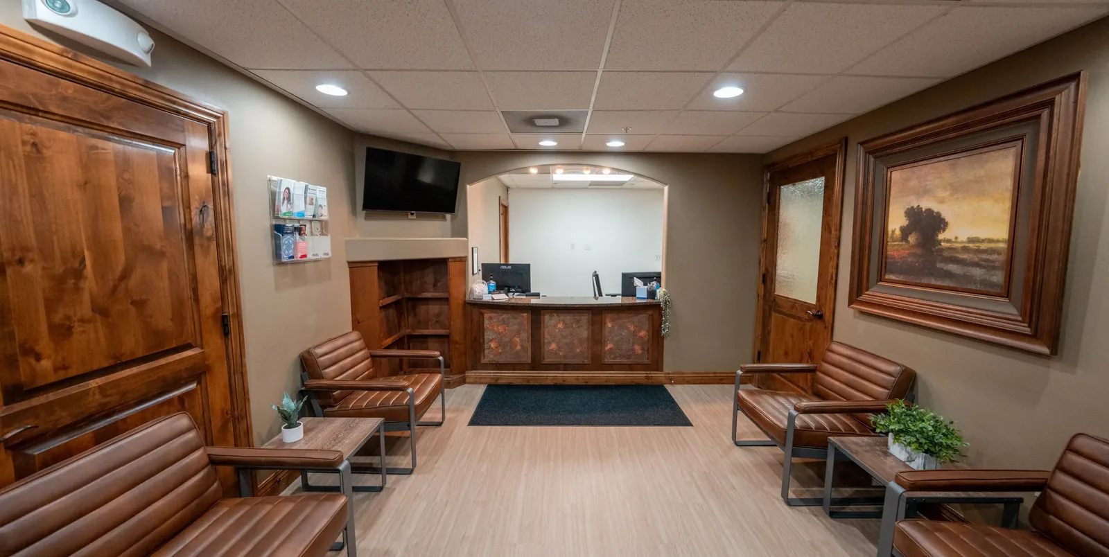 Cottonwood Heights reception desk and waiting area with leather seating | Complete Smiles-Cottonwood Heights-Mountain View-Redwood-Utah