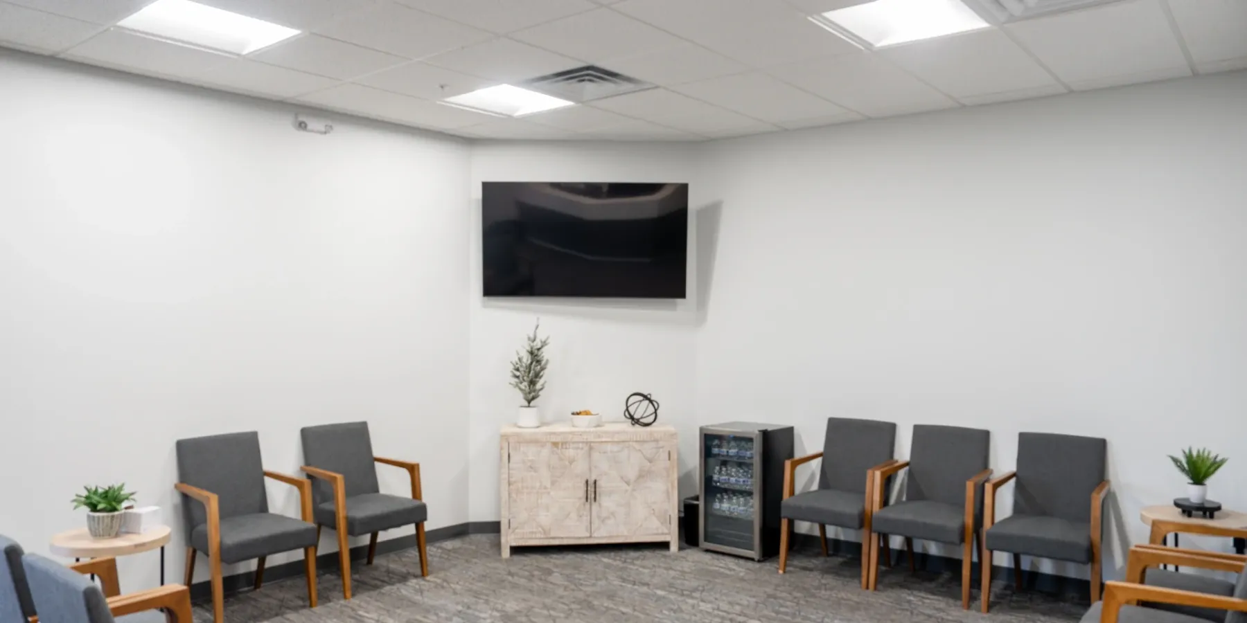 Mountain View waiting room with comfortable seating and a wall-mounted TV | Complete Smiles-Cottonwood Heights-Mountain View-Redwood-Utah