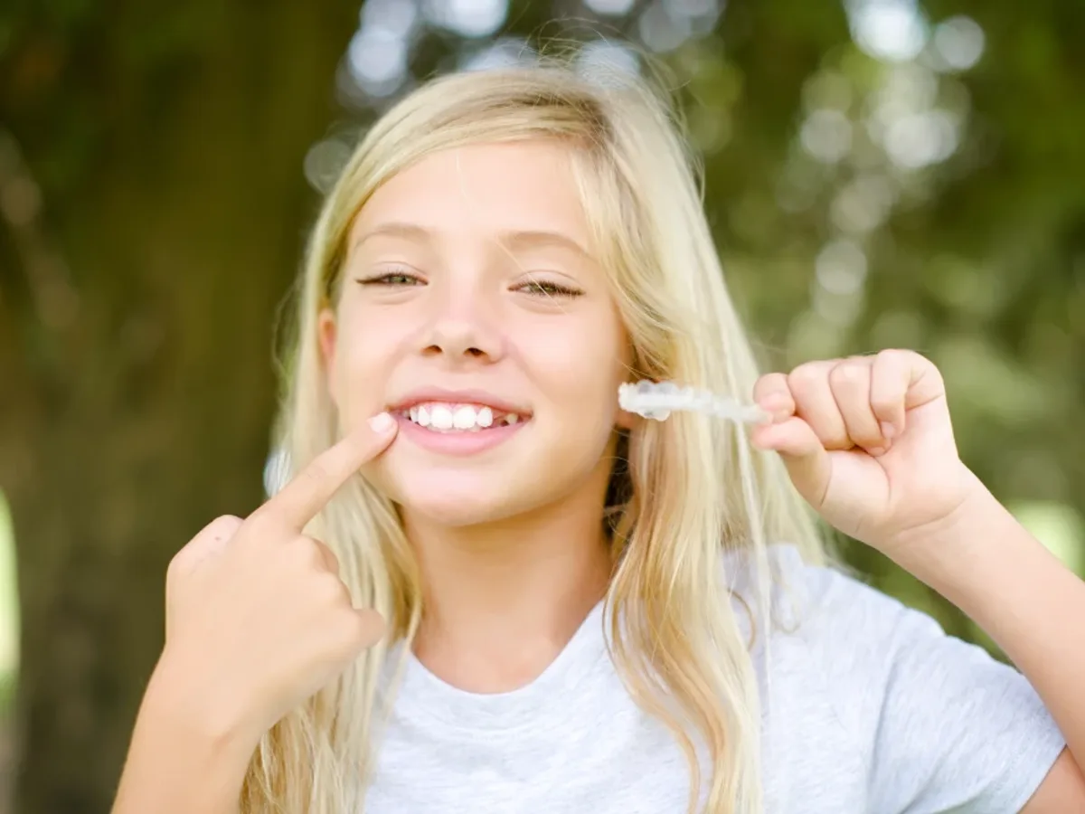 A teenage patient holding her clear aligner | Complete Smiles-Cottonwood Heights-Mountain View-Redwood-Utah