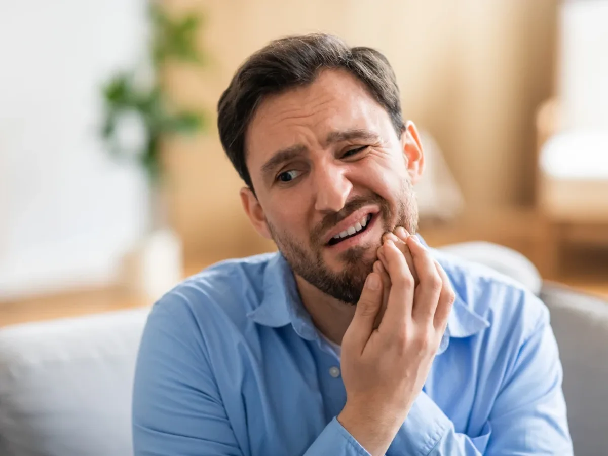 A man holding his jaw in discomfort before an emergency visit | Complete Smiles-Cottonwood Heights-Mountain View-Redwood-Utah