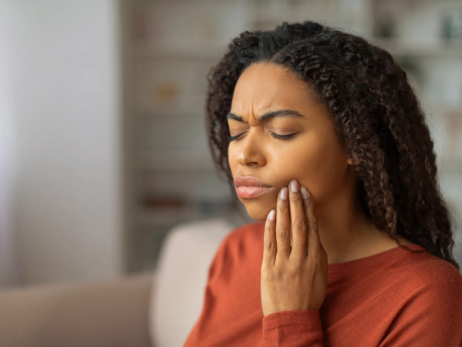 A woman holding her jaw in pain before an emergency visit | Complete Smiles-Cottonwood Heights-Mountain View-Redwood-Utah